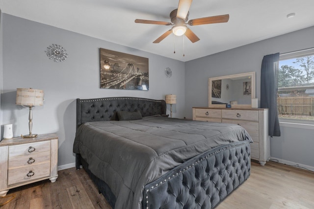 bedroom with hardwood / wood-style flooring and ceiling fan