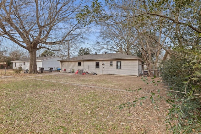 rear view of house featuring a lawn