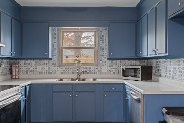 kitchen with sink, stainless steel appliances, and blue cabinetry