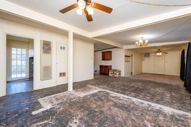 unfurnished living room with ceiling fan with notable chandelier and a wall mounted AC