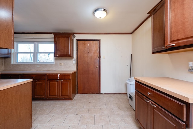 kitchen featuring decorative backsplash and ornamental molding