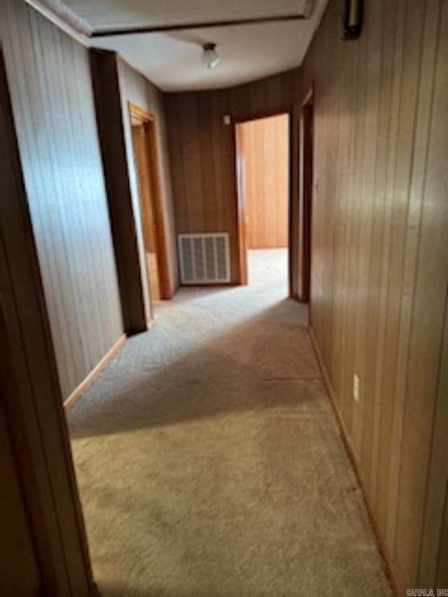 1985 Old Wire Rd, Camden, AR 71701 - corridor with light carpet, wooden walls, and visible vents