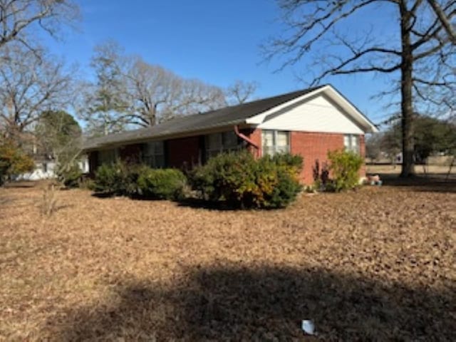 view of side of home featuring brick siding