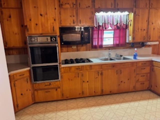 1985 Old Wire Rd, Camden, AR 71701 - kitchen featuring light floors, a sink, light countertops, brown cabinets, and black appliances