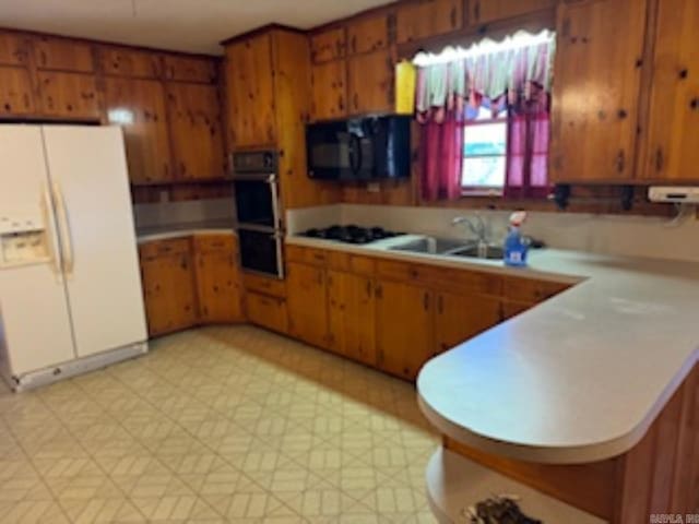 1985 Old Wire Rd, Camden, AR 71701 - kitchen featuring light floors, a sink, light countertops, black appliances, and brown cabinetry