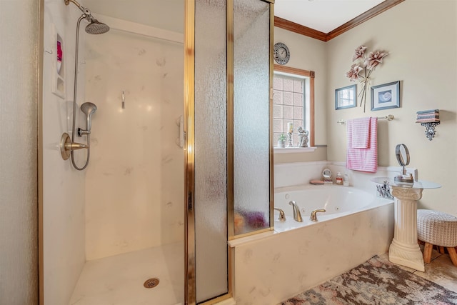 bathroom with ornamental molding and separate shower and tub