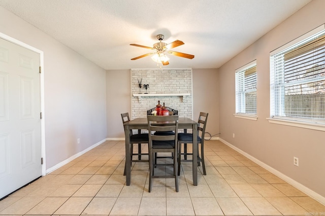 dining area with light tile patterned floors, a textured ceiling, and ceiling fan