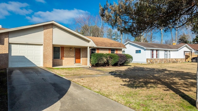 ranch-style house featuring a garage and a front lawn