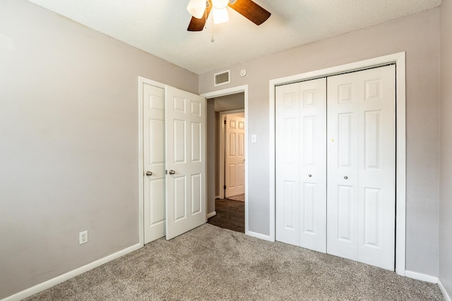 unfurnished bedroom with light carpet, a closet, and ceiling fan