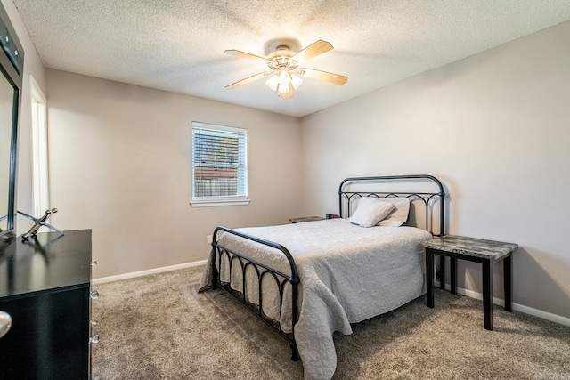 carpeted bedroom featuring a textured ceiling and ceiling fan