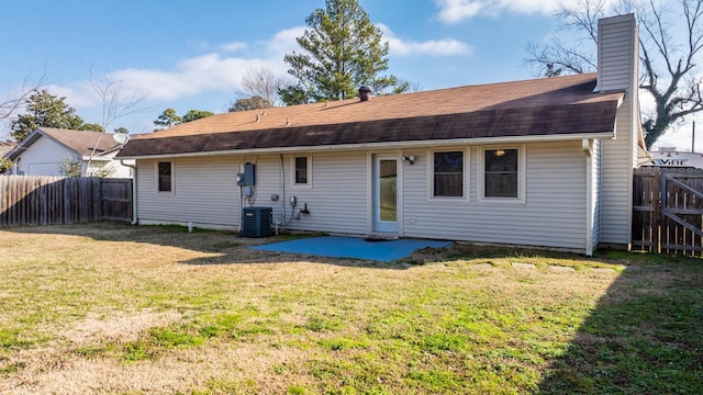 back of property with a patio area and a lawn