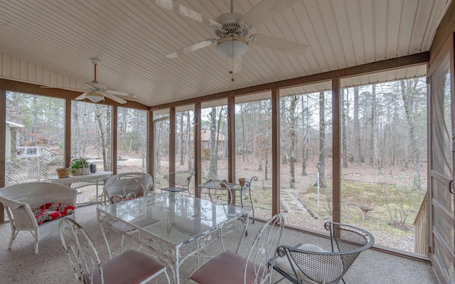 unfurnished sunroom with lofted ceiling, ceiling fan, and a healthy amount of sunlight