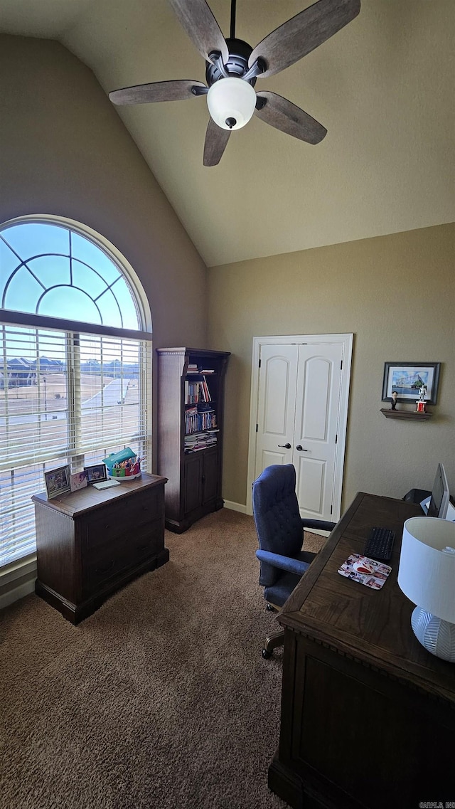 carpeted home office featuring vaulted ceiling and ceiling fan