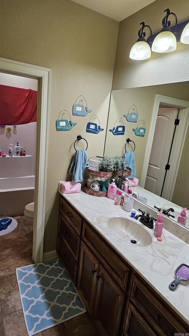 full bathroom with vanity, tile patterned flooring,  shower combination, and toilet