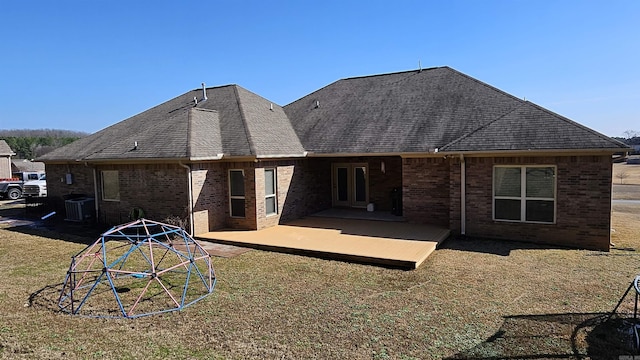 rear view of property featuring central AC, a patio, and a lawn