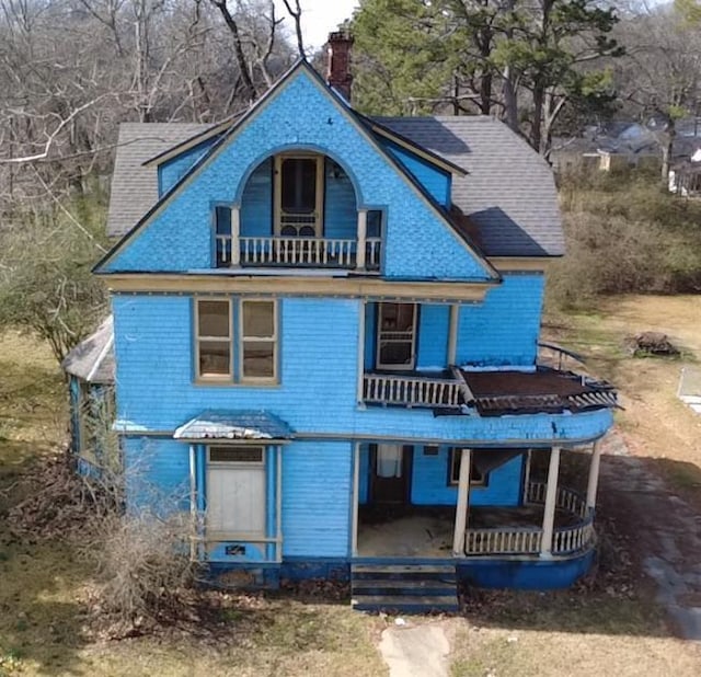 victorian-style house with a balcony and a porch