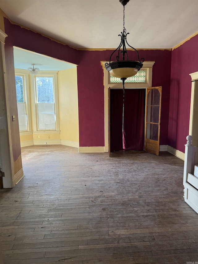 unfurnished dining area featuring dark hardwood / wood-style flooring