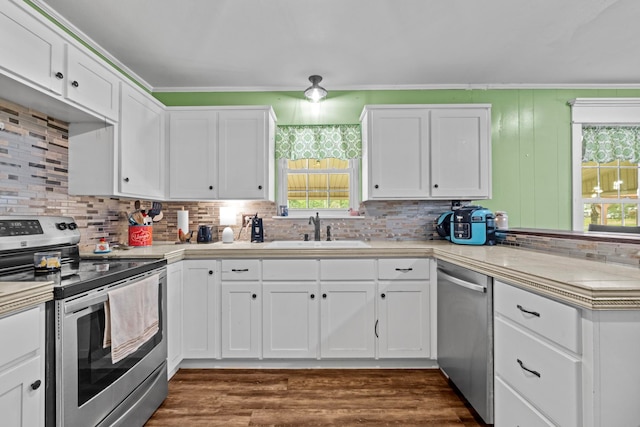 kitchen featuring appliances with stainless steel finishes, sink, white cabinets, and dark hardwood / wood-style flooring