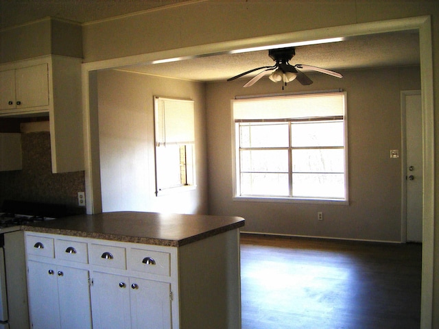 kitchen featuring white cabinetry, kitchen peninsula, dark hardwood / wood-style floors, and ceiling fan