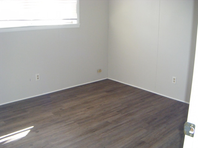 spare room with dark hardwood / wood-style floors