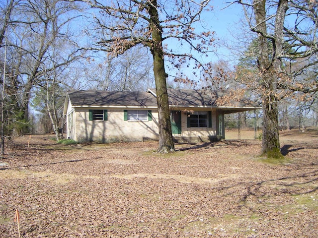 ranch-style home featuring a carport