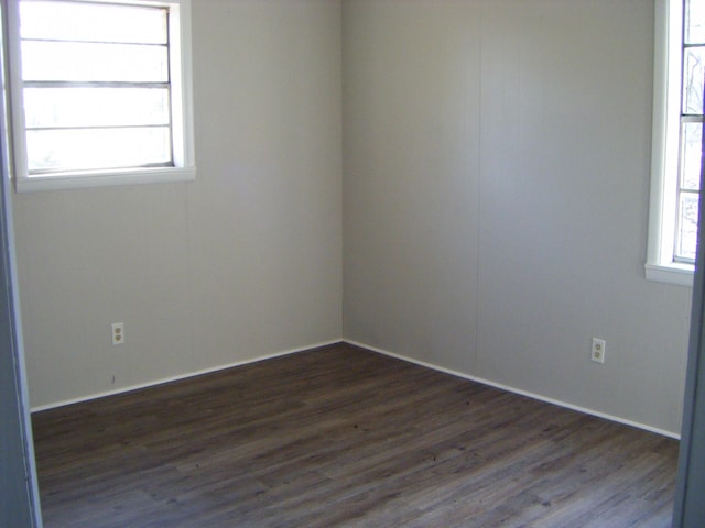 spare room featuring dark hardwood / wood-style floors