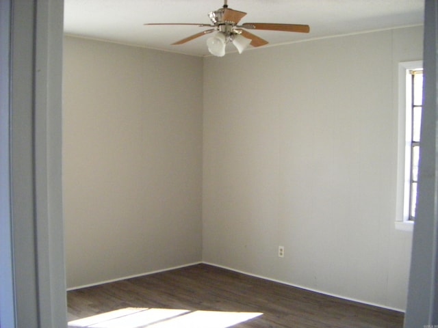 unfurnished room featuring dark wood-type flooring and ceiling fan