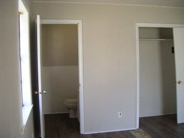 unfurnished bedroom featuring dark hardwood / wood-style floors and a closet