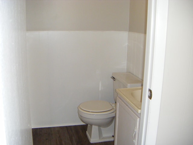 bathroom featuring vanity, wood-type flooring, and toilet