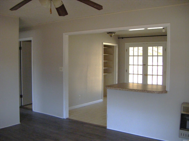 spare room with dark hardwood / wood-style floors, heating unit, ceiling fan, and french doors