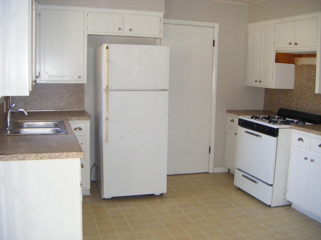 kitchen featuring white appliances, sink, decorative backsplash, and white cabinets