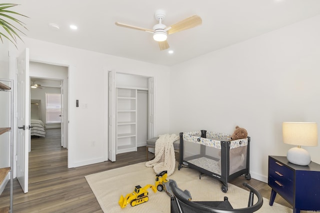 exercise area with dark hardwood / wood-style floors and ceiling fan