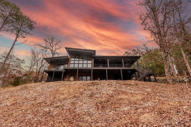 view of back house at dusk