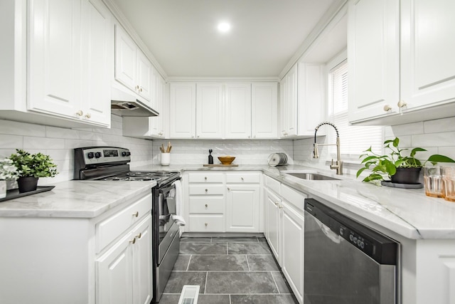 kitchen with white cabinetry, appliances with stainless steel finishes, sink, and decorative backsplash