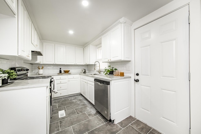 kitchen featuring sink, white cabinetry, light stone counters, appliances with stainless steel finishes, and decorative backsplash