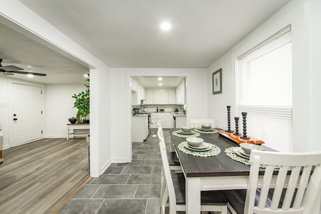 dining room with dark hardwood / wood-style floors and ceiling fan