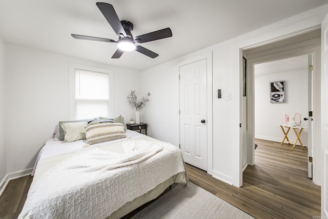 bedroom with ceiling fan and dark hardwood / wood-style flooring