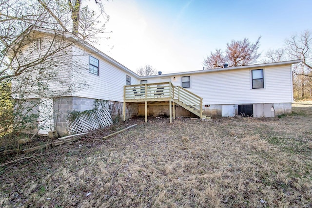 back of house with a wooden deck