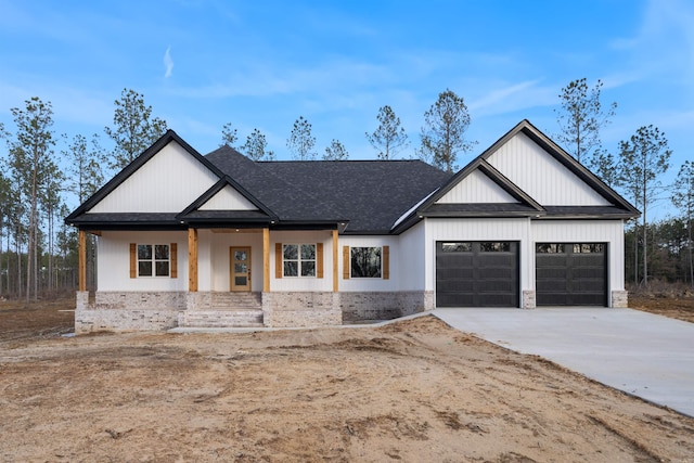 modern farmhouse with driveway, a garage, roof with shingles, a porch, and brick siding