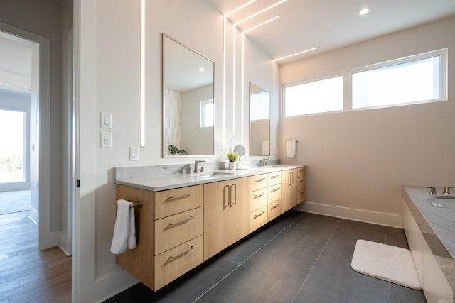 bathroom with vanity, a wealth of natural light, and tile patterned floors