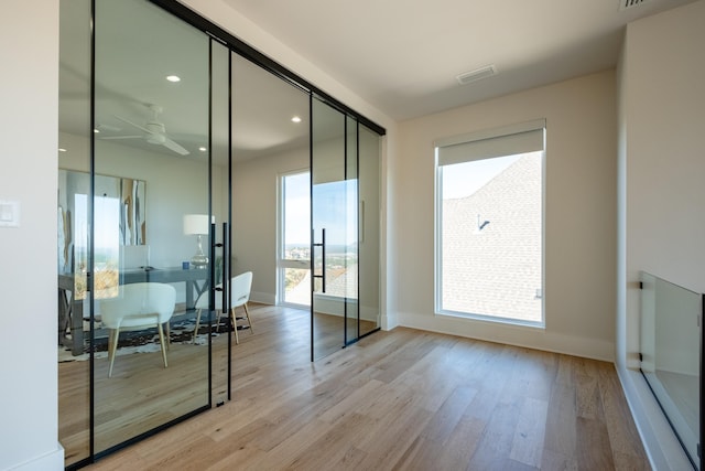 interior space with ceiling fan and light wood-type flooring