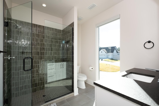 bathroom featuring vanity, an enclosed shower, tile patterned floors, and toilet