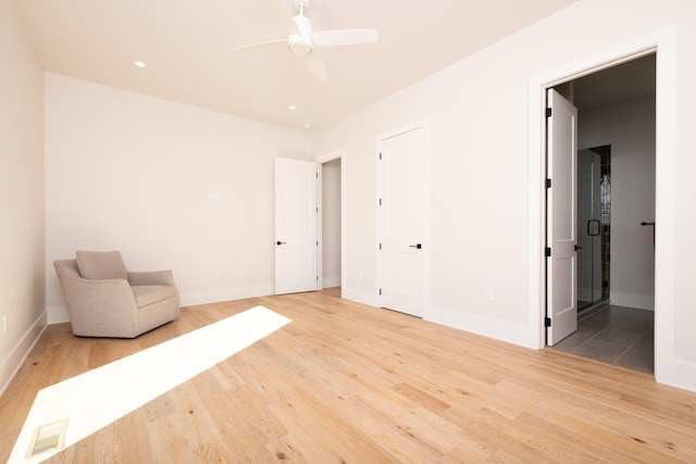 unfurnished room featuring ceiling fan and light hardwood / wood-style floors