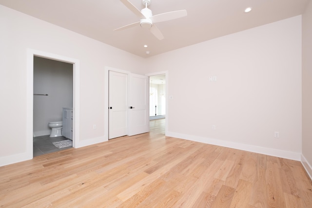 unfurnished bedroom with ceiling fan, connected bathroom, and light hardwood / wood-style floors