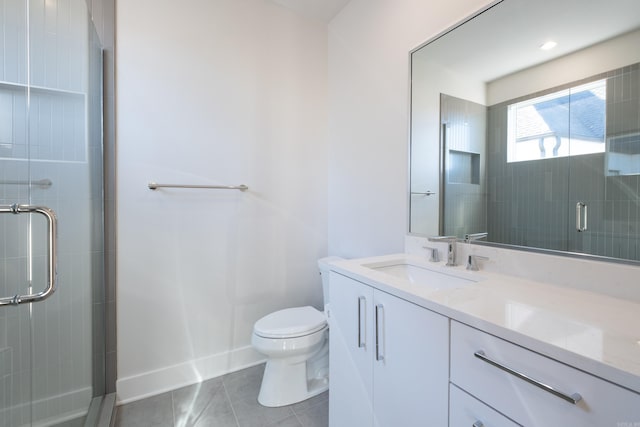 bathroom featuring vanity, a shower with shower door, tile patterned floors, and toilet