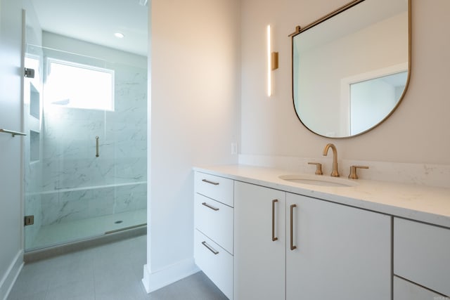 bathroom with vanity, an enclosed shower, and tile patterned flooring