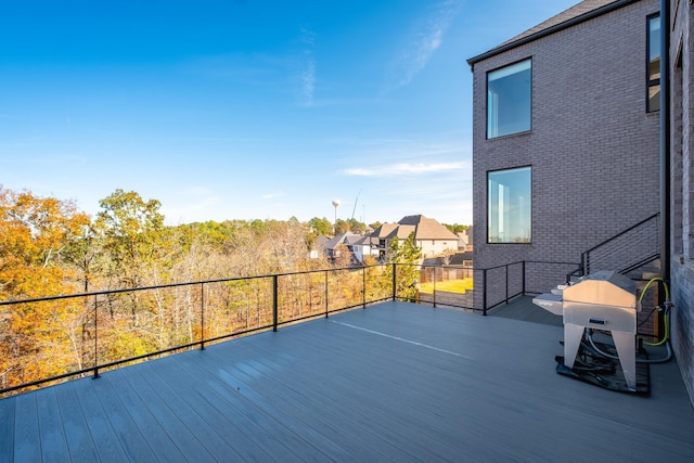 wooden deck with a grill