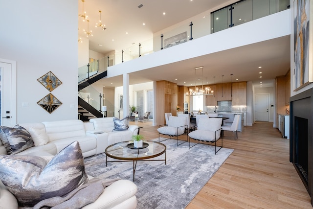 living room featuring a chandelier and light hardwood / wood-style floors