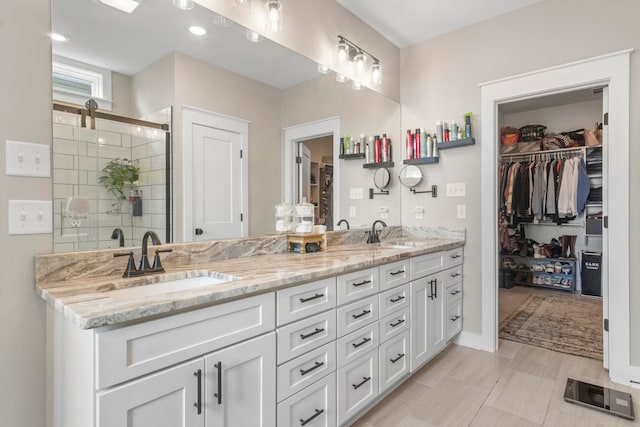 bathroom featuring vanity and an enclosed shower