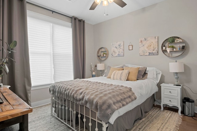 bedroom with light hardwood / wood-style floors and ceiling fan